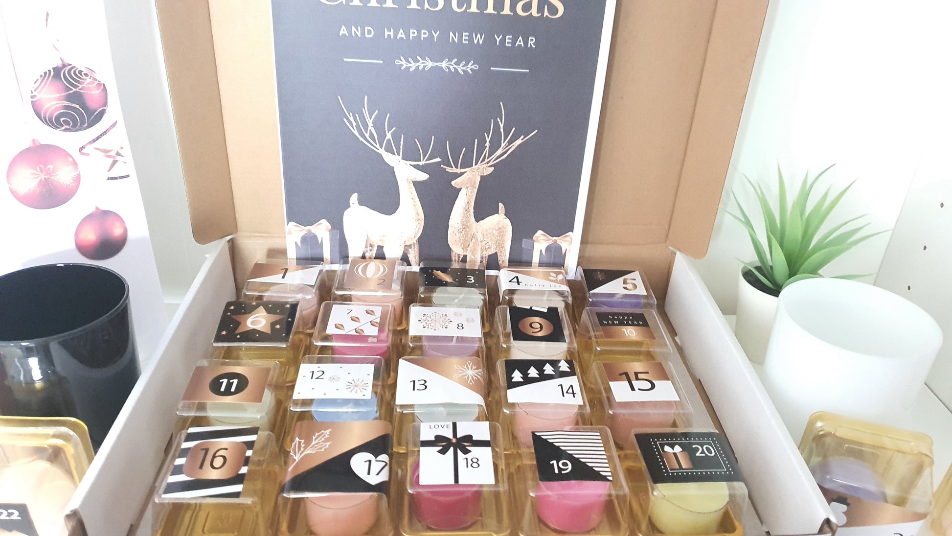  advent calendar with small doors, each numbered, in a box with Christmas decorations in the background