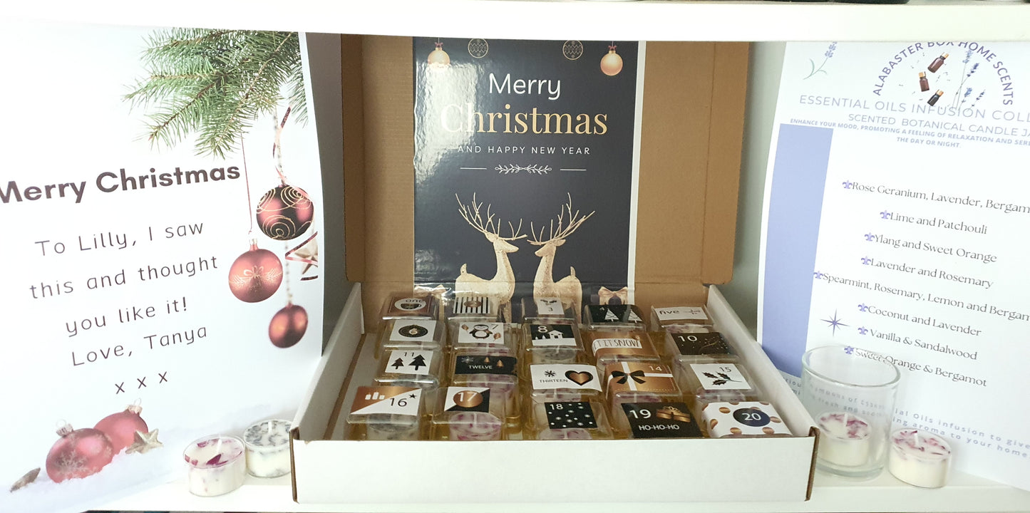 Box of tealight candles with a Christmas card and decorative items on a white background