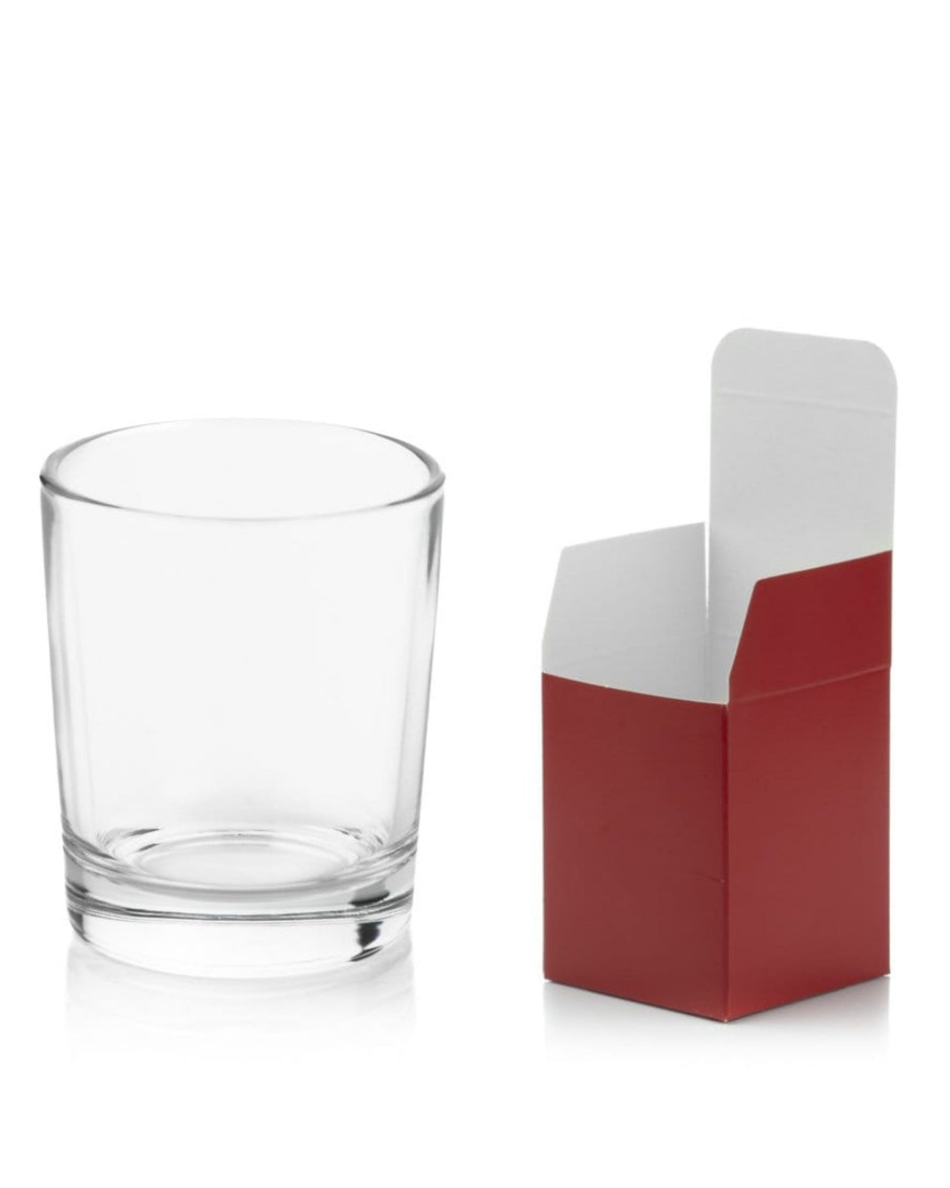 Clear glass tumbler next to a red and white box on a white background