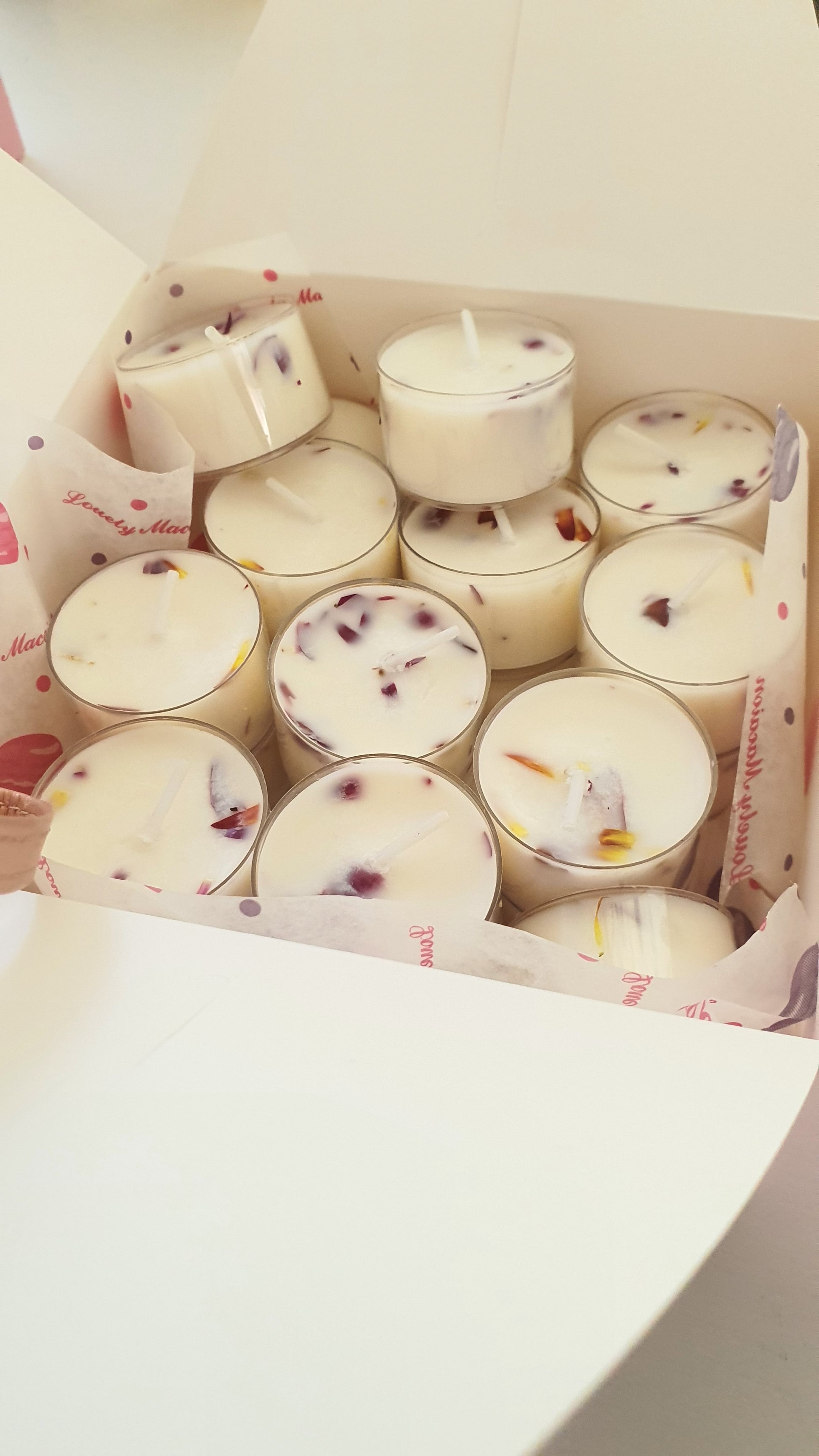 Box of small candles with visible branding on a light background