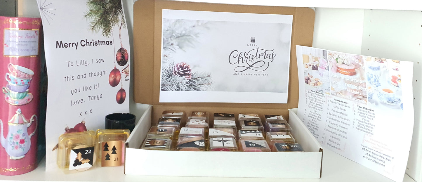 Tea light scented candle box set with tealight candles,  a card, and a tea light candle holder  on a white surface.